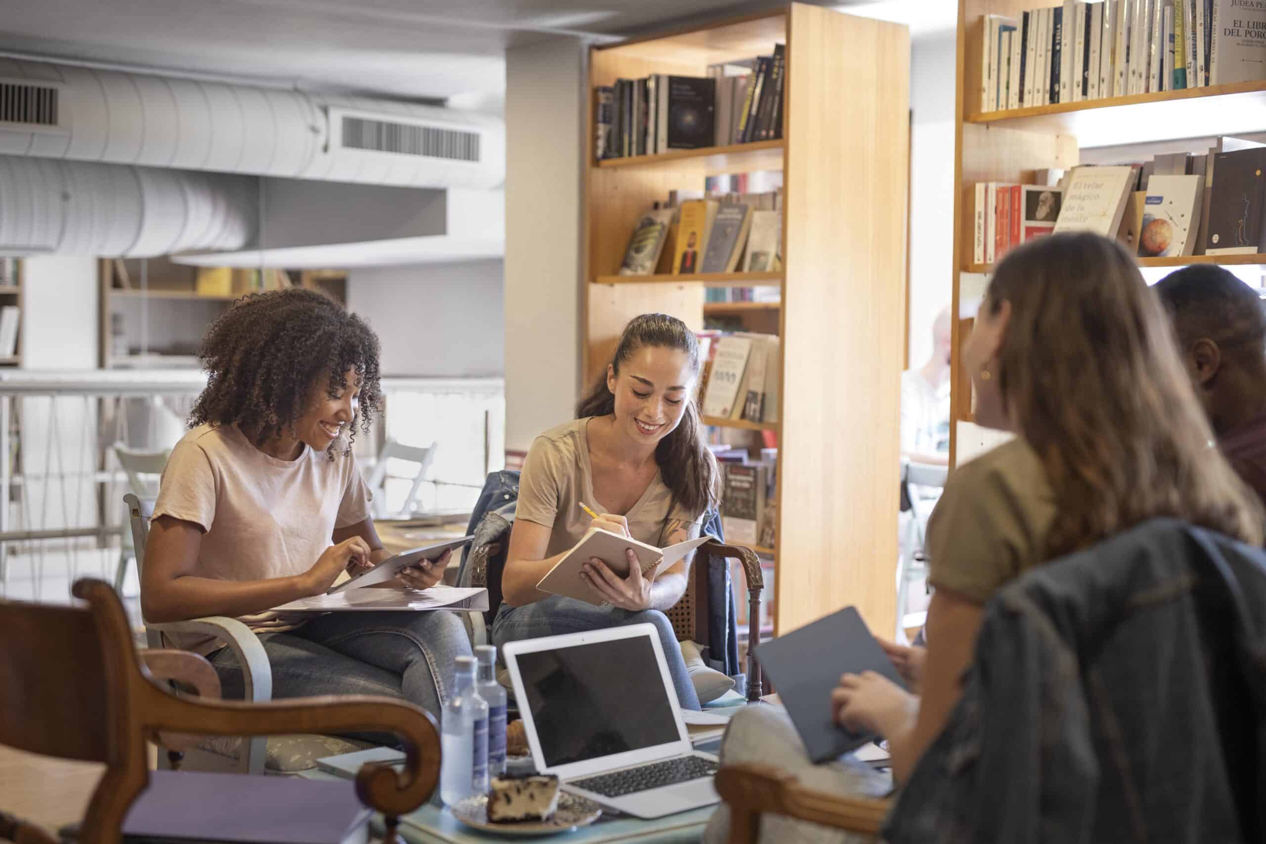 Four students work together in a library.