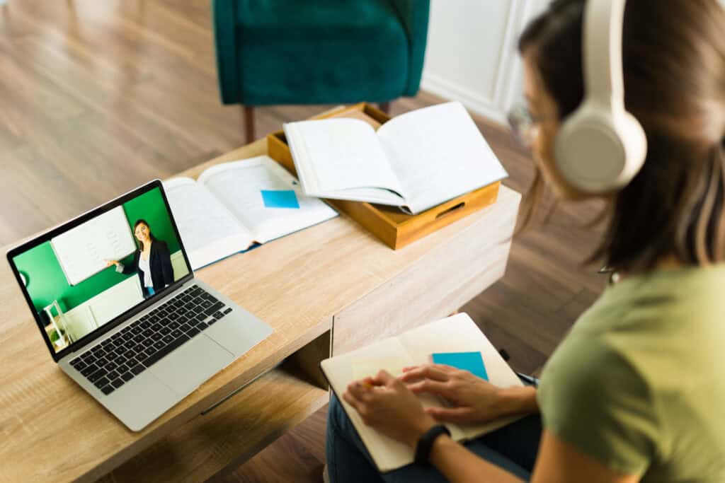 A university student watches an online lecture.