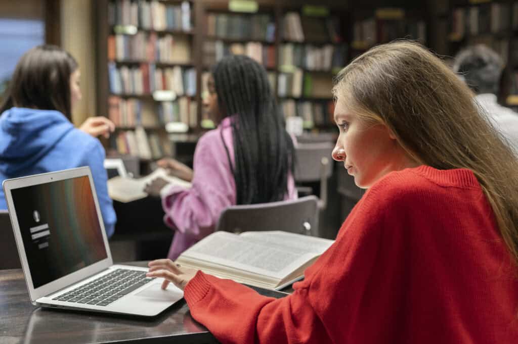 A student using her laptop while studying.