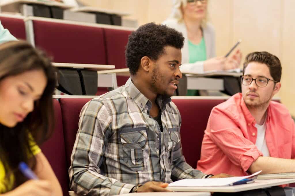 Students discuss the impact of predictive analytics in education in a lecture